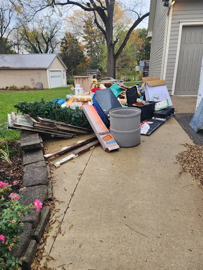 Dumpster being loaded with debris for Estate Cleanout Dumpster Rental in Los Altos